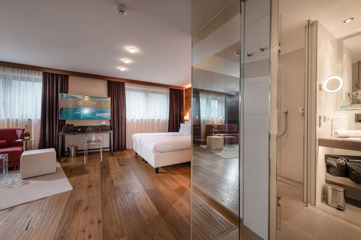 junior suite, 1 king bed (lifestyle large) | living area | tv