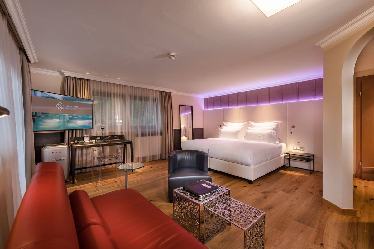 junior suite, 1 king bed (lifestyle large) | living area | tv