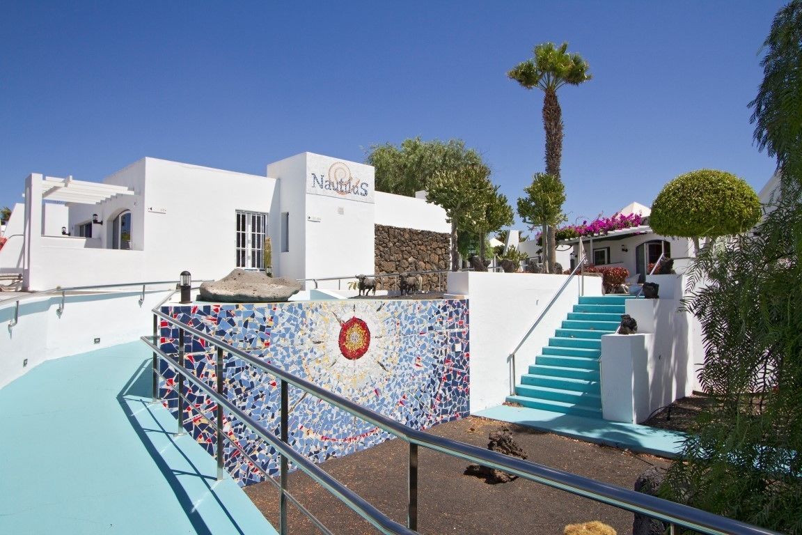 A white building with a sign reading "Nautilus."