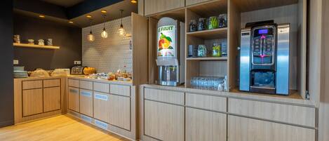 A modern kitchen with wooden cabinets, a fruit dispenser, and a KREX refrigerator.