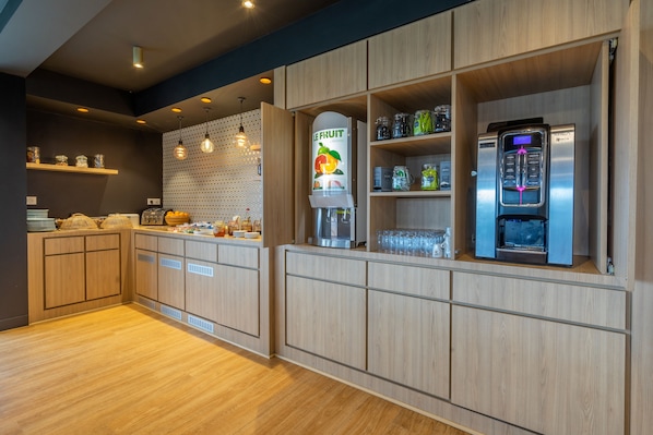 A modern kitchen with wooden cabinets, a fruit dispenser, and a KREX refrigerator.