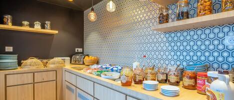 A breakfast bar with various food items and condiments.