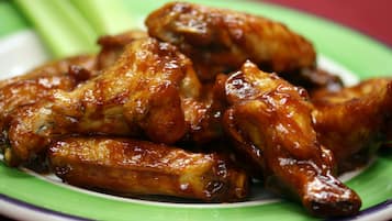 A plate of glazed chicken wings.