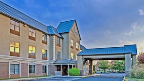 A hotel with a covered entrance, multiple windows, and a brick facade. - Country Inn & Suites by Radisson, Salisbury, MD (Salisbury)