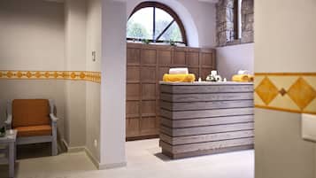 Enjoy a clean and functional bathroom with a wooden vanity, comfortable chair, and large window.