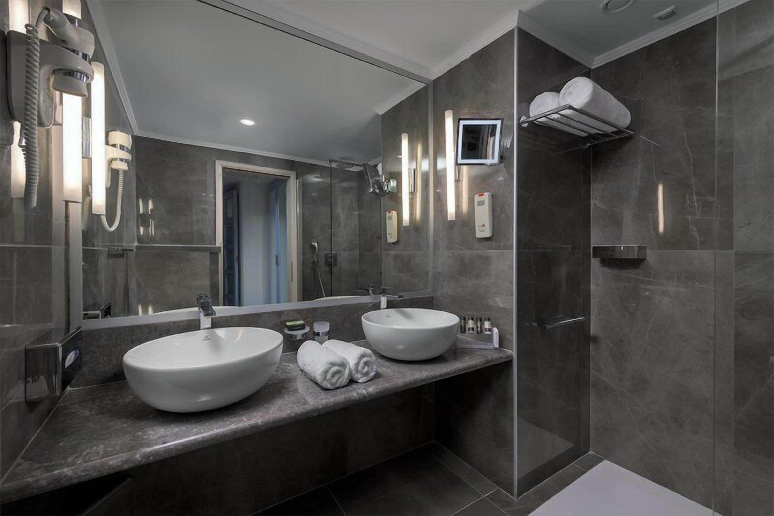 Eco-friendly toiletries, hair dryer, slippers, towels