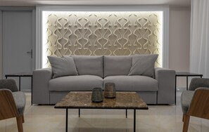 Una sala moderna con un sofá gris, dos sillones, una mesa de centro y lámparas decorativas.