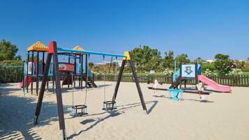 Kids can play on swings, slides, and climbing areas in this playground.