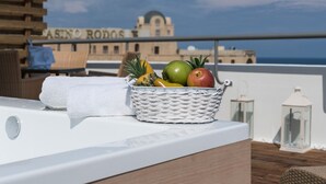 A wicker basket with fruits on a balcony overlooking a building with "CASINO RODOS" sign. - City Center Hotel (Rhodes)