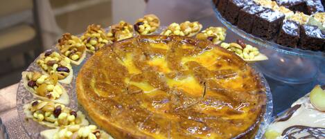 A dessert display with various cakes and pastries.