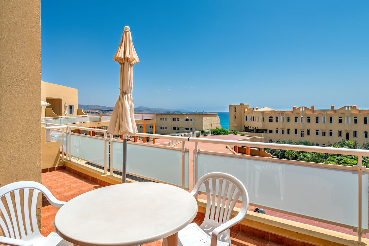 Apartment, 1 Bedroom, Sea View | 1 bedroom, blackout drapes, iron/ironing board, free cribs/infant beds