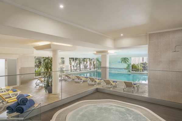 Una piscina techada, 2 piscinas al aire libre, sombrillas