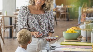 A buffet setup with various food items and a person serving. - Dorisol Buganvilia Studio Hotel (Funchal)