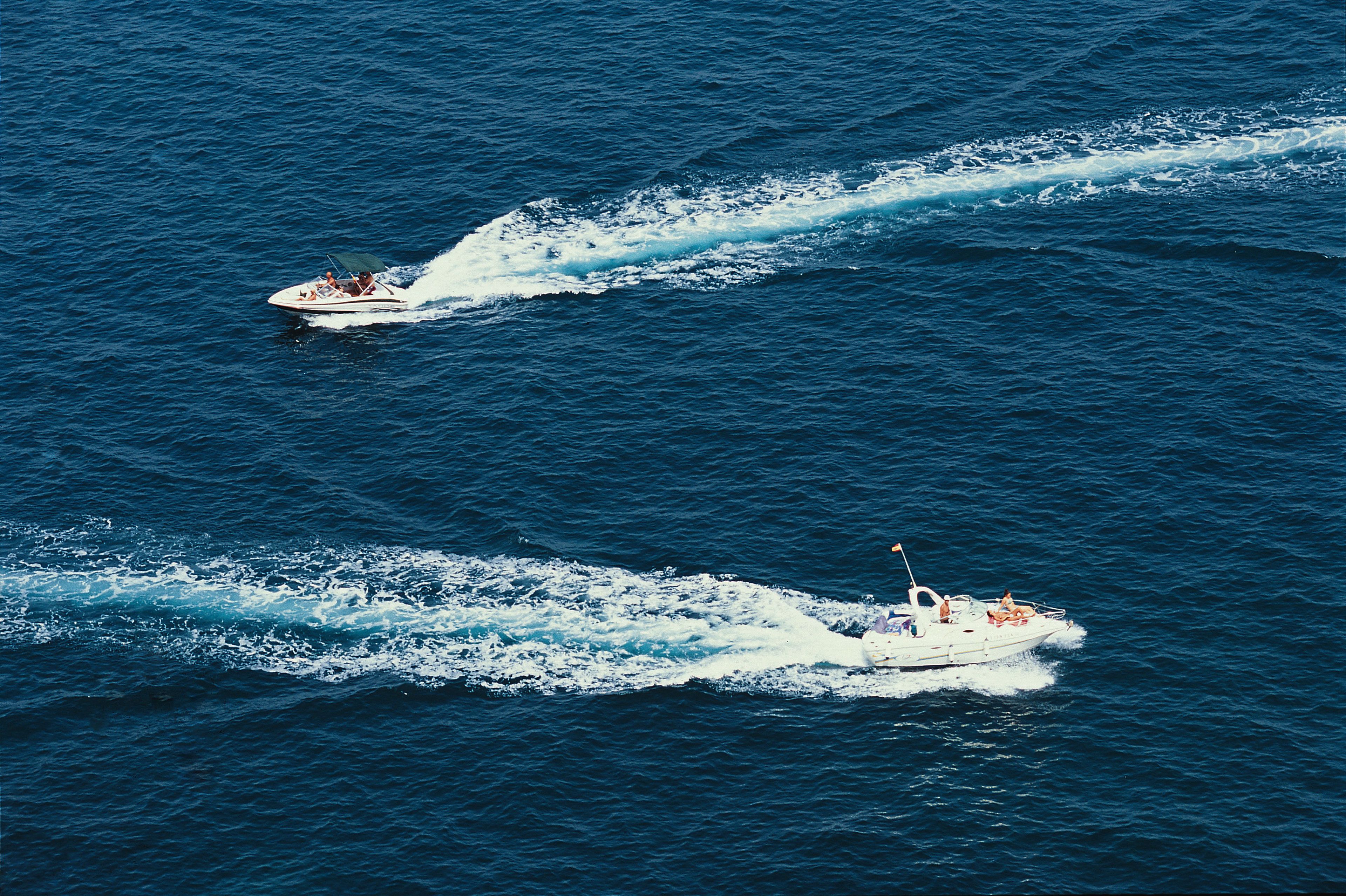Two speedboats on a body of water.
