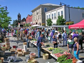 A bustling outdoor market with vendors and shoppers. - Holiday Inn Express & Suites Milton by IHG (Milton)