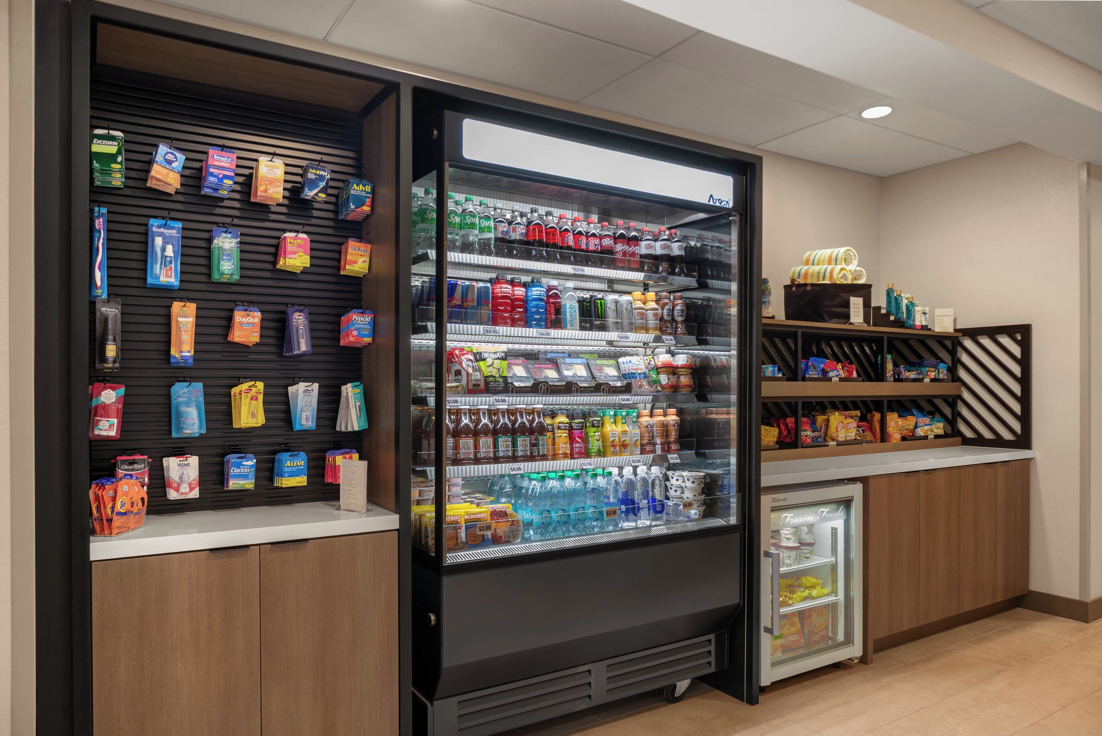 A self-service beverage dispenser with various drinks and snacks.