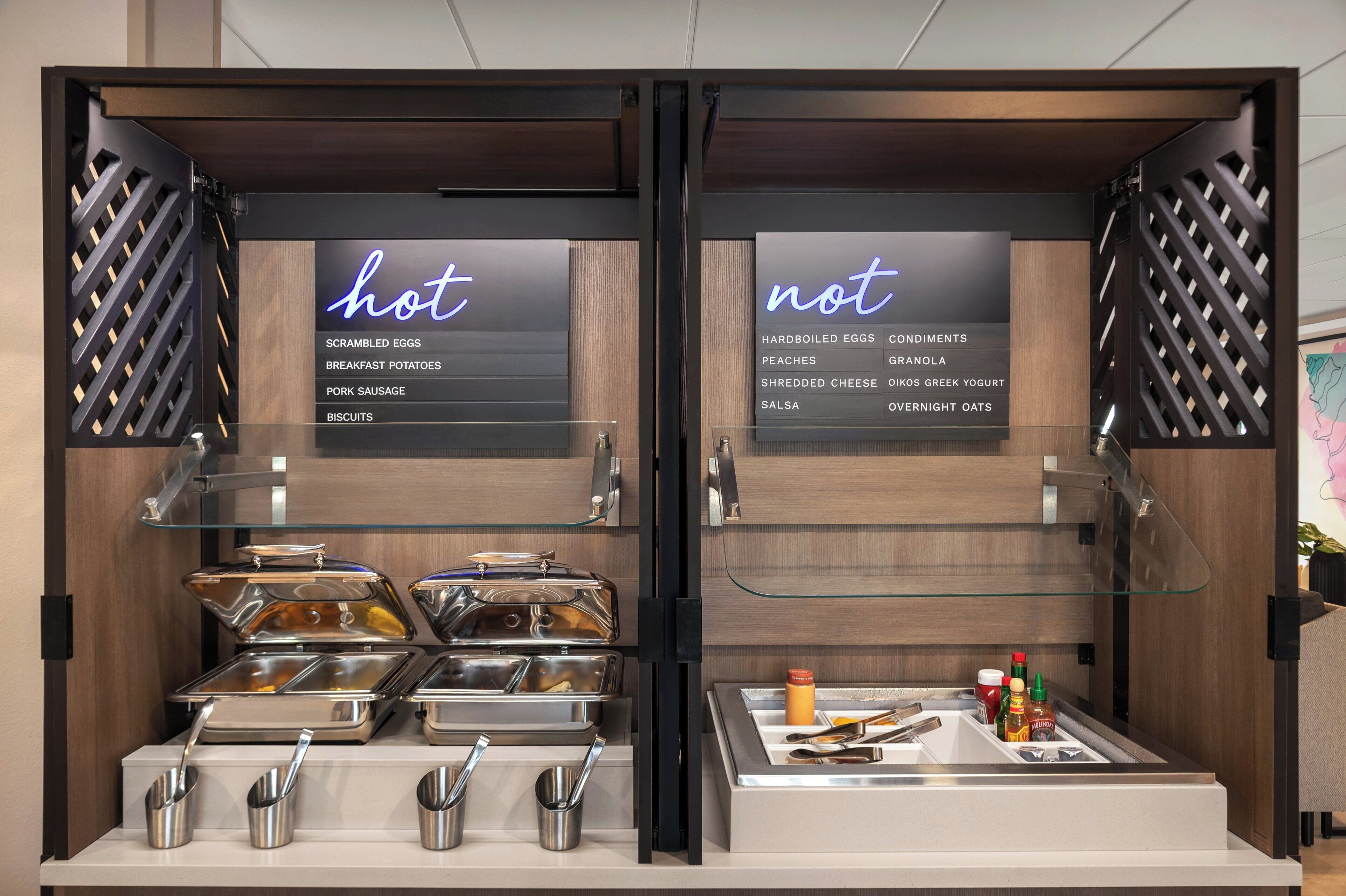 A breakfast buffet with two sections labeled 'hot' and 'not,' featuring various food items and condiments.