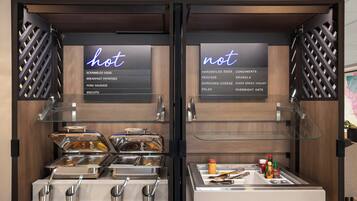 A breakfast buffet with two sections labeled 'hot' and 'not,' featuring various food items and condiments.