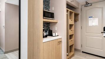 A modern kitchen with wooden cabinets, a microwave, and a countertop.
