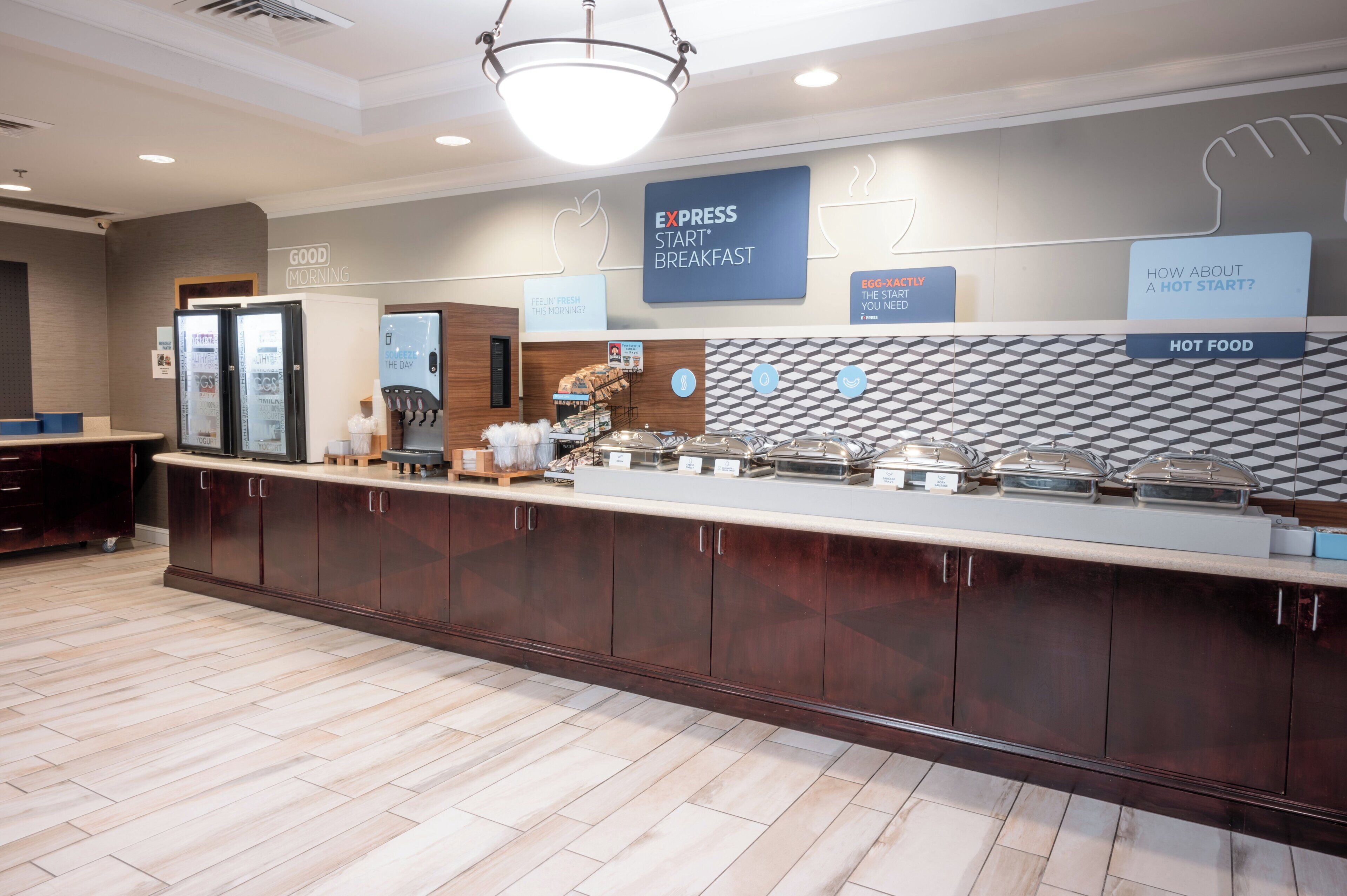 A breakfast bar with a sign reading "EXPRESS START BREAKFAST" and a sign for "HOT FOOD".