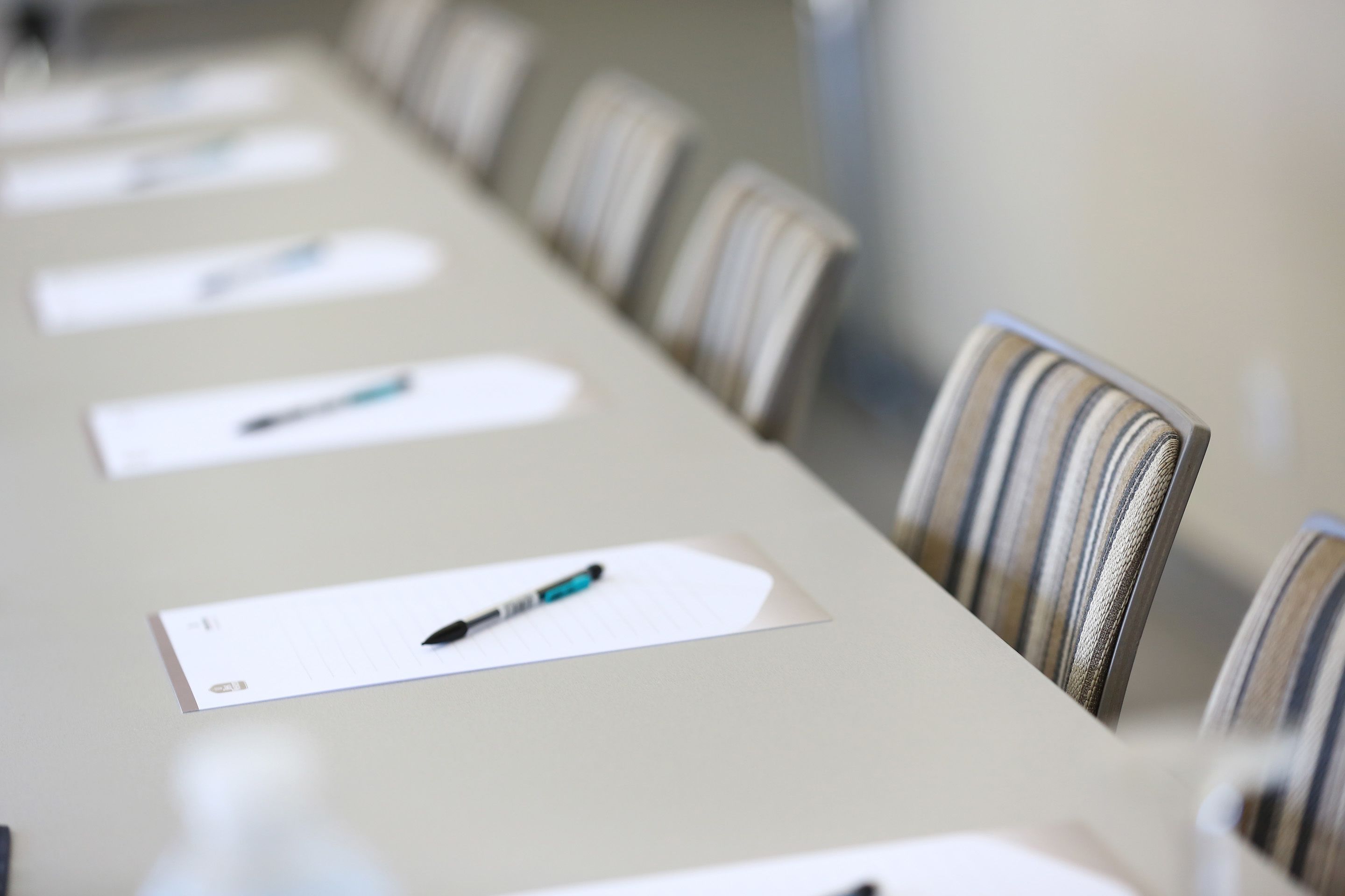 A conference table with chairs and name cards.