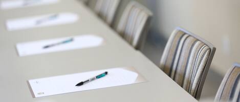 A conference table with chairs and name cards.
