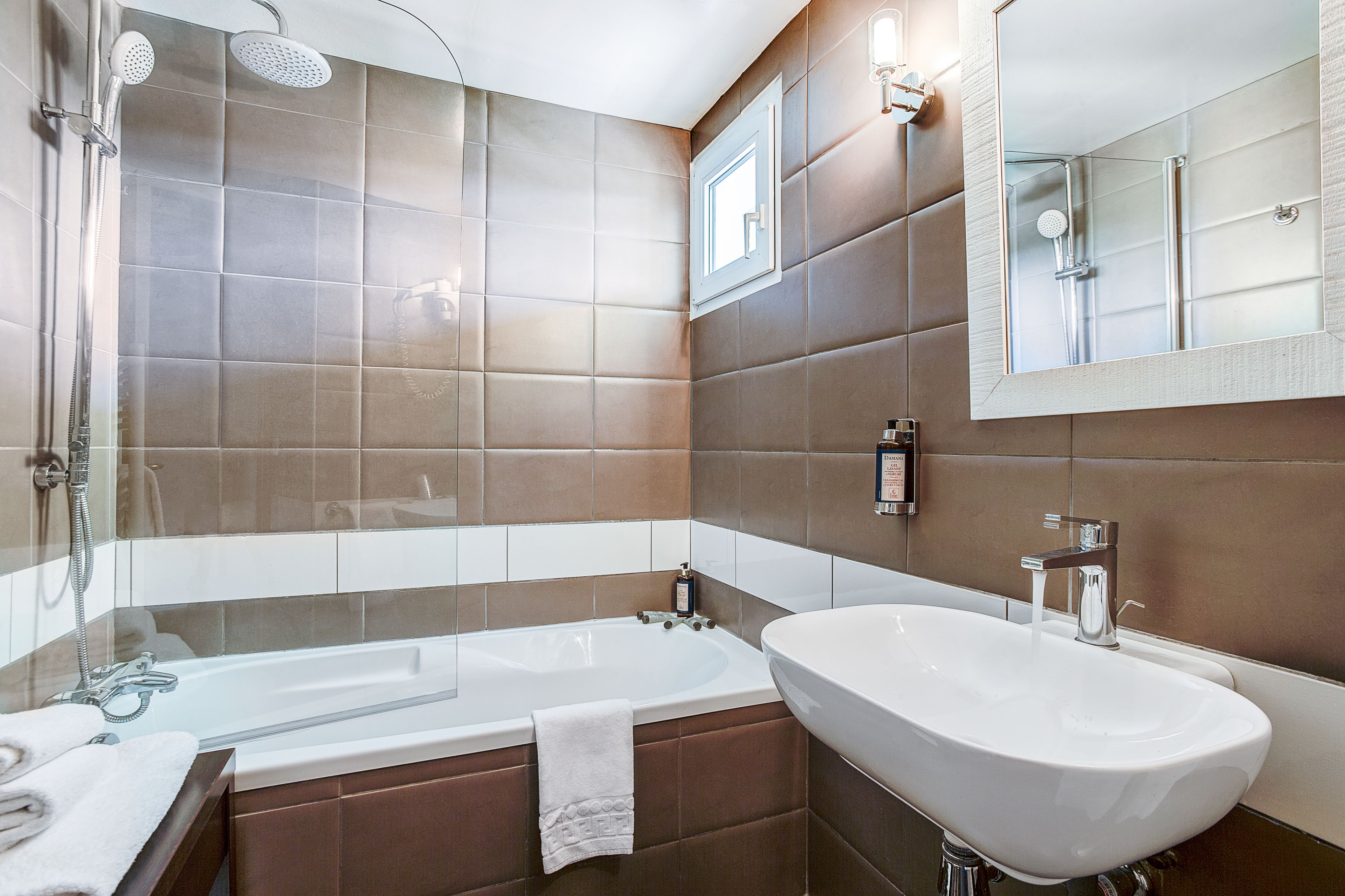 A modern bathroom with a bathtub, a sink, and a shower.