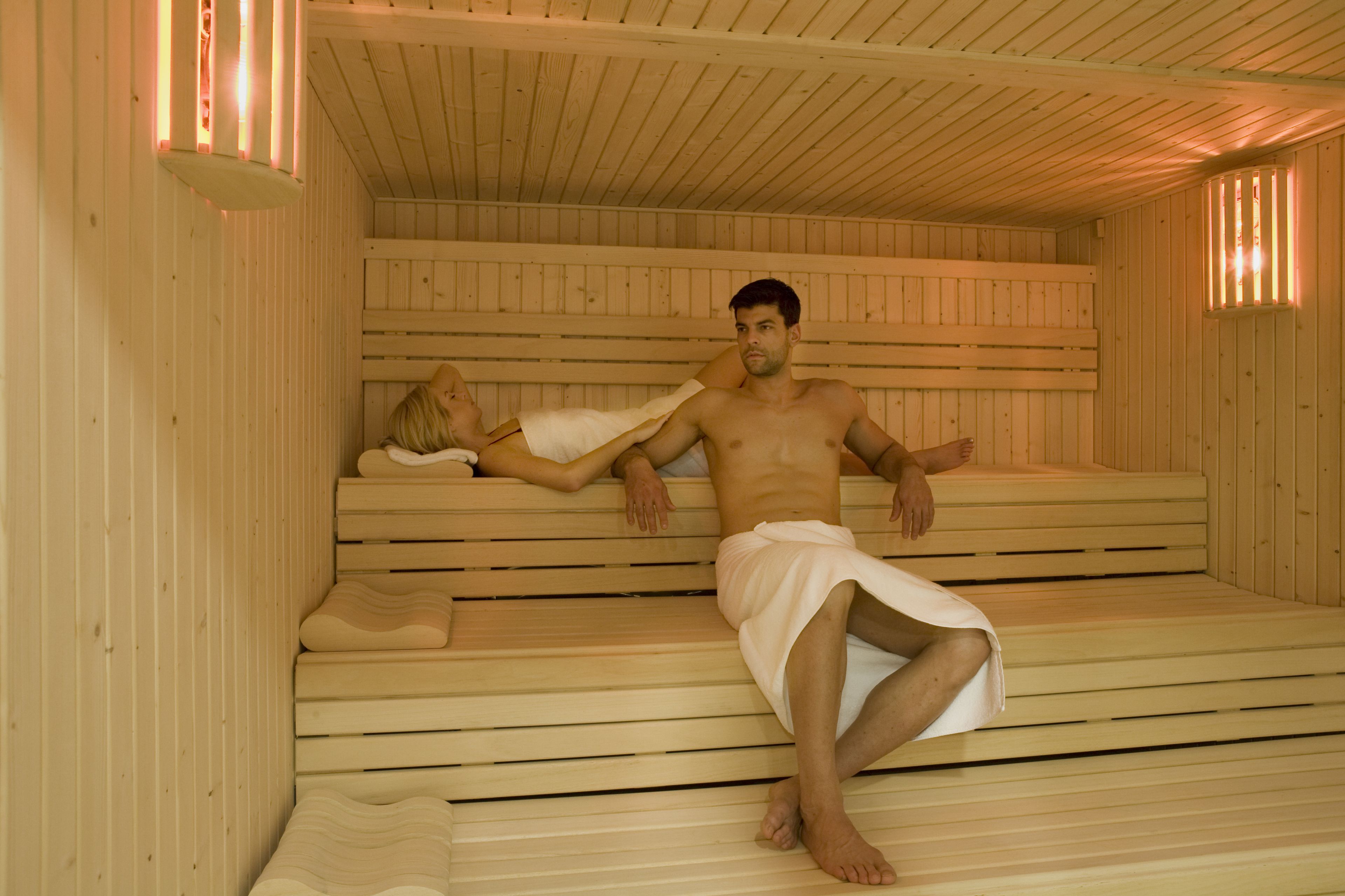 A sauna with wooden benches and benches with footrests.