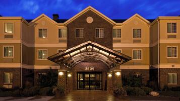 A multi-story hotel with a prominent entrance number 2505, featuring a brick facade and a symmetrical design.