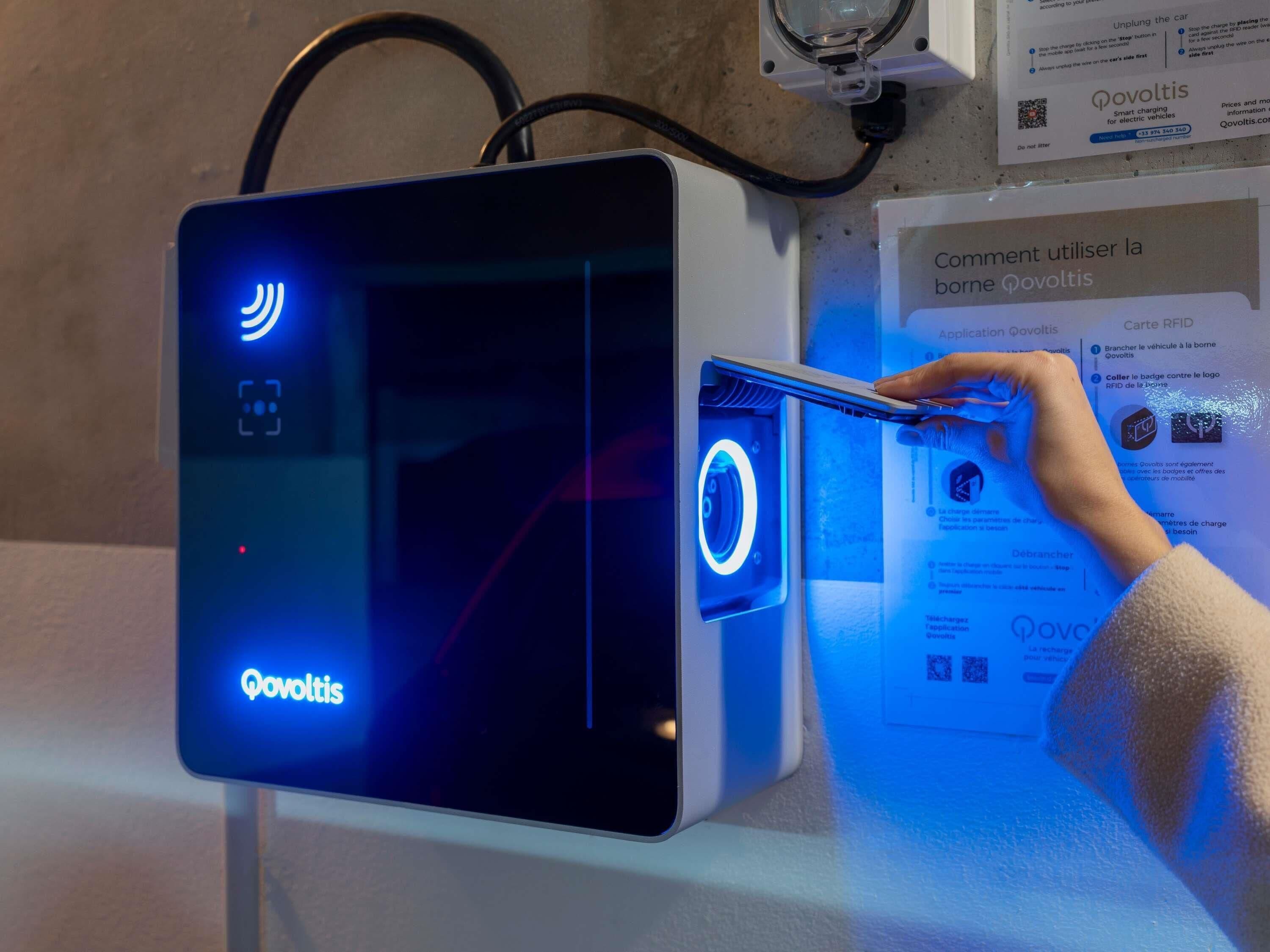 A charging station with a digital display and a QR code.
