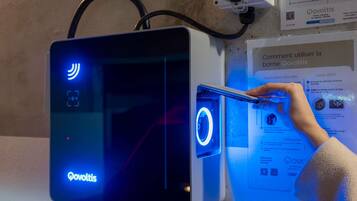 A charging station with a digital display and a QR code.