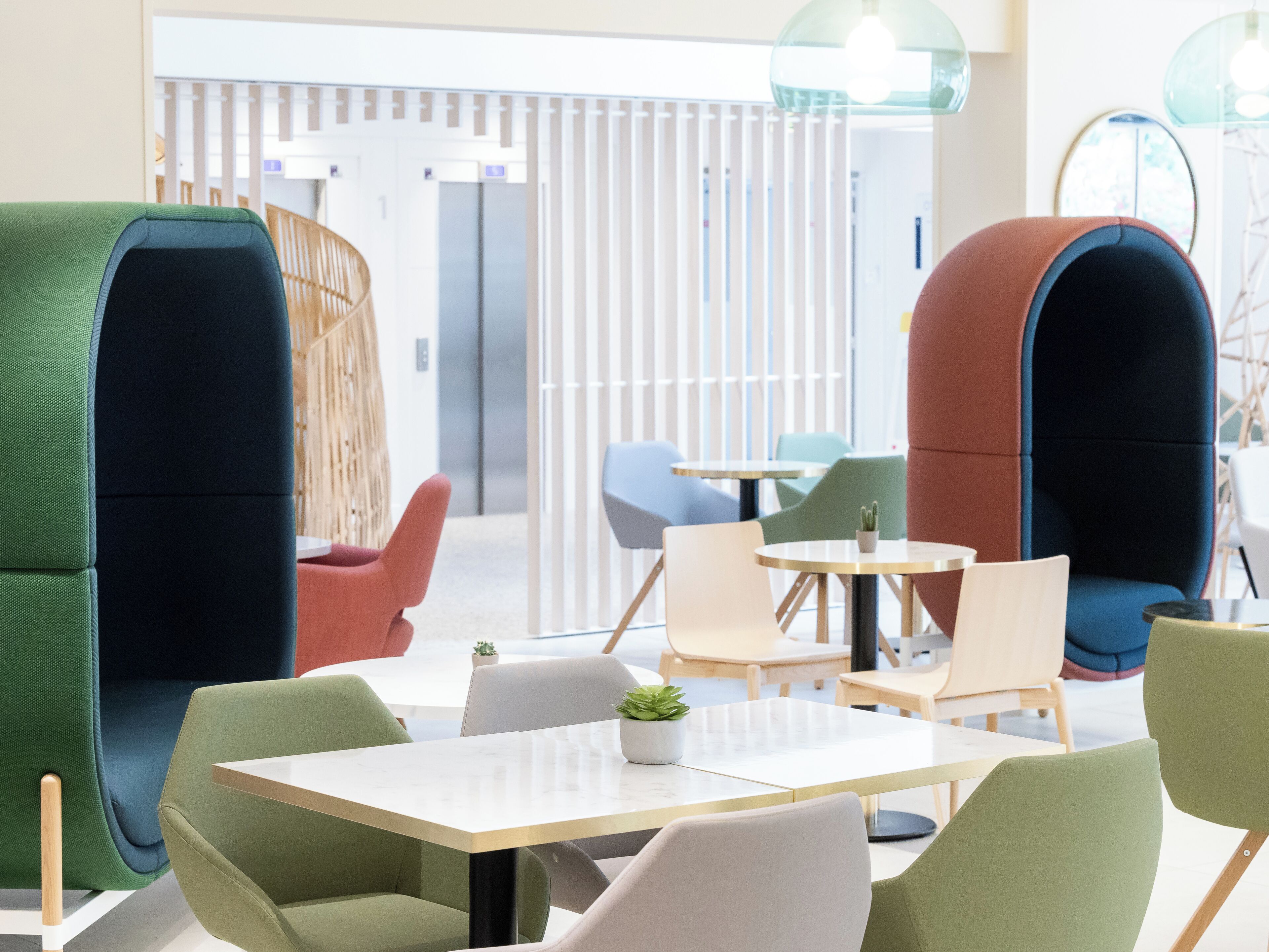 A modern lounge area with seating arrangements and a small table.