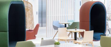 A modern lounge area with seating arrangements and a small table.
