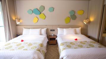 A hotel room with two beds, a wooden floor, and a wall with hexagonal wall art.