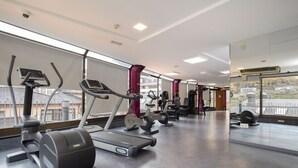 A gym with treadmills, elliptical machines, and weight equipment.