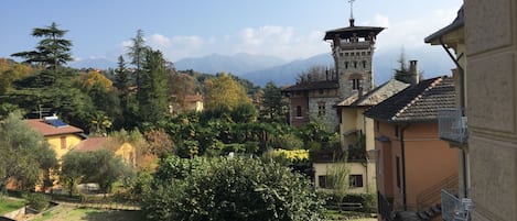 A view of a town with a prominent tower, surrounded by trees and buildings.