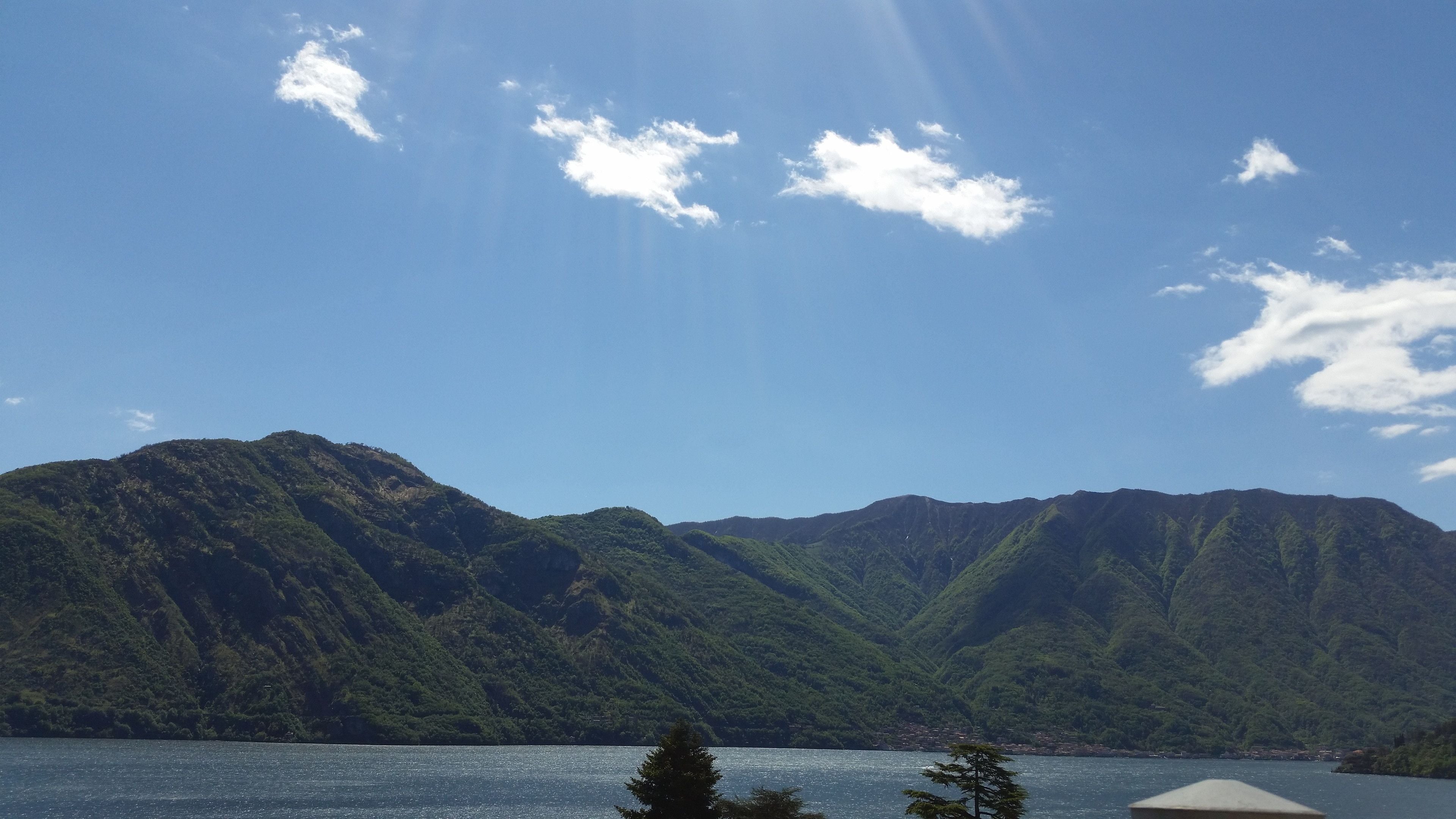 A mountainous landscape with a lake in the foreground and a clear sky.