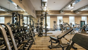 A gym with various exercise equipment, including dumbbells, weight machines, and cardio machines. - Prestige Treasure Cove Resort (Prince George)
