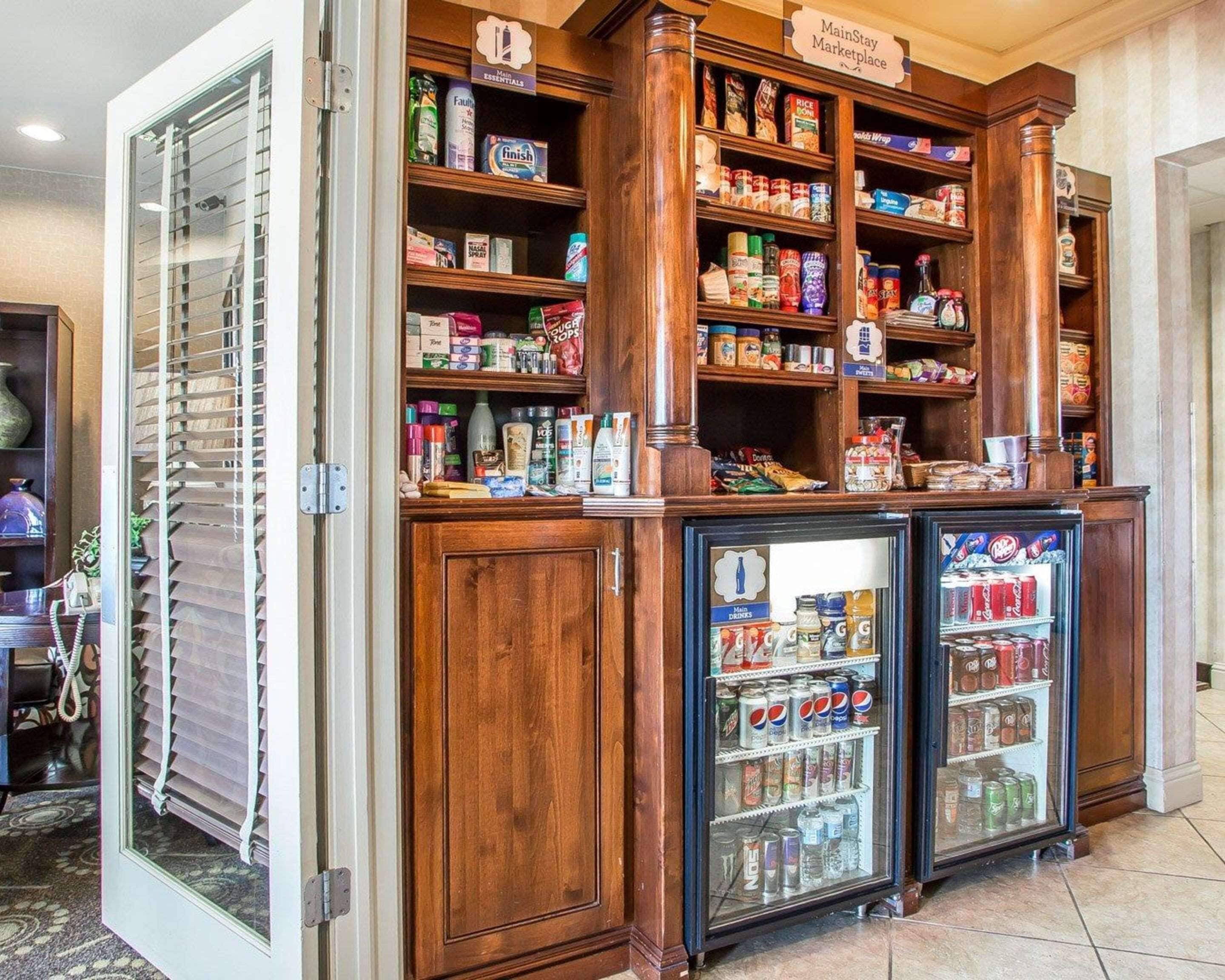 A MainStay Marketplace with shelves stocked with various food items and a refrigerated section with beverages.
