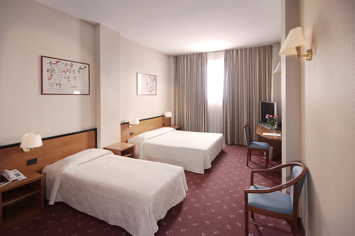 Standard Triple Room | Minibar, in-room safe, desk, soundproofing
