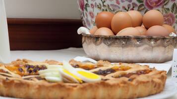 A breakfast plate with eggs and a slice of pizza.