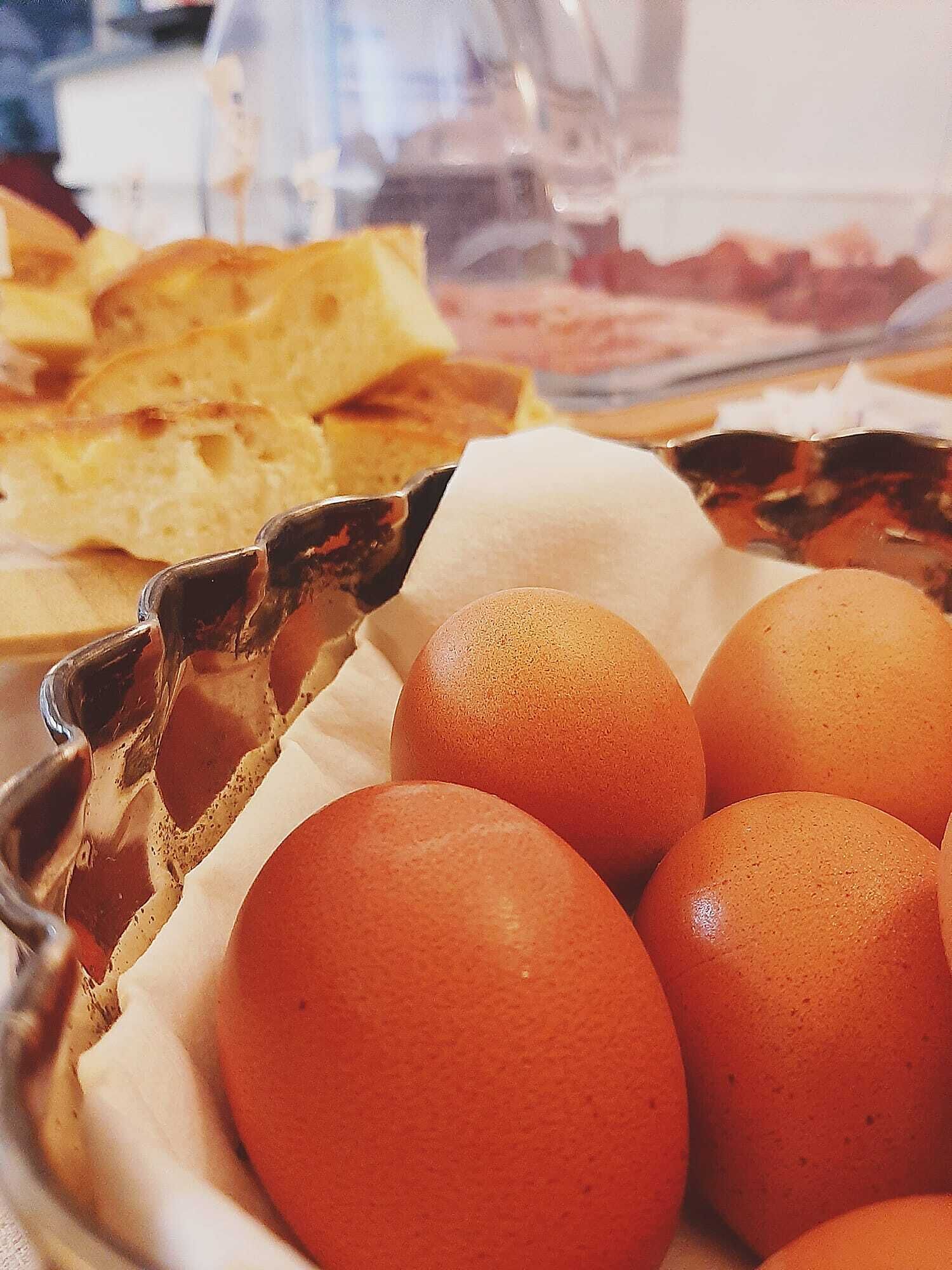 A tray of eggs and bread in a bakery setting.