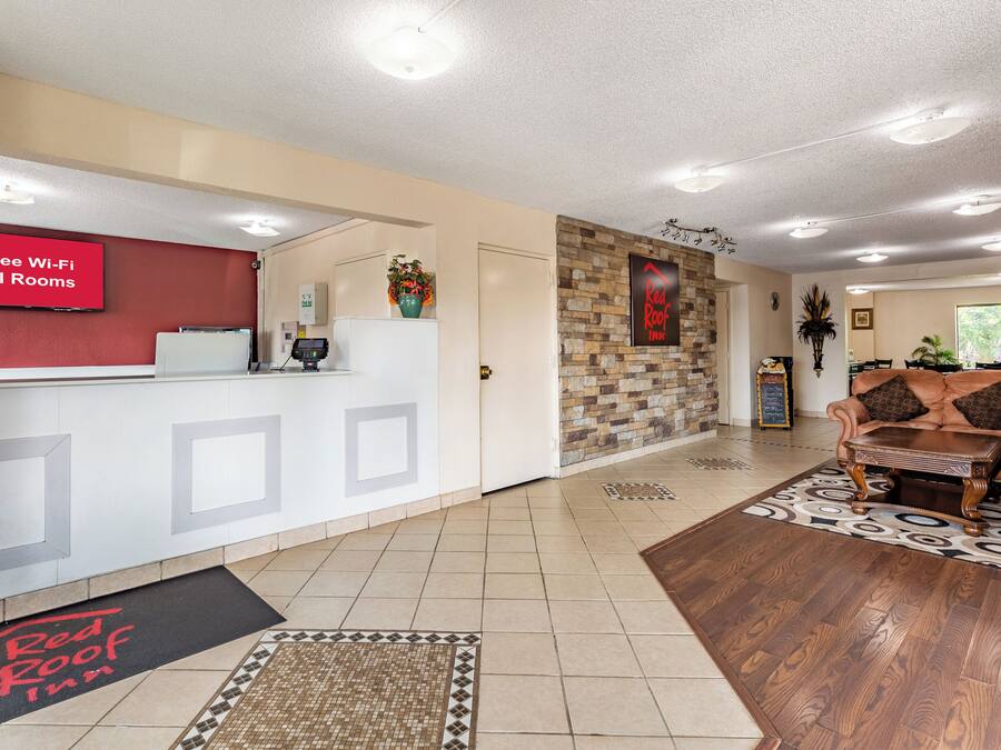 A hotel reception area with a sign indicating free Wi-Fi in all rooms.