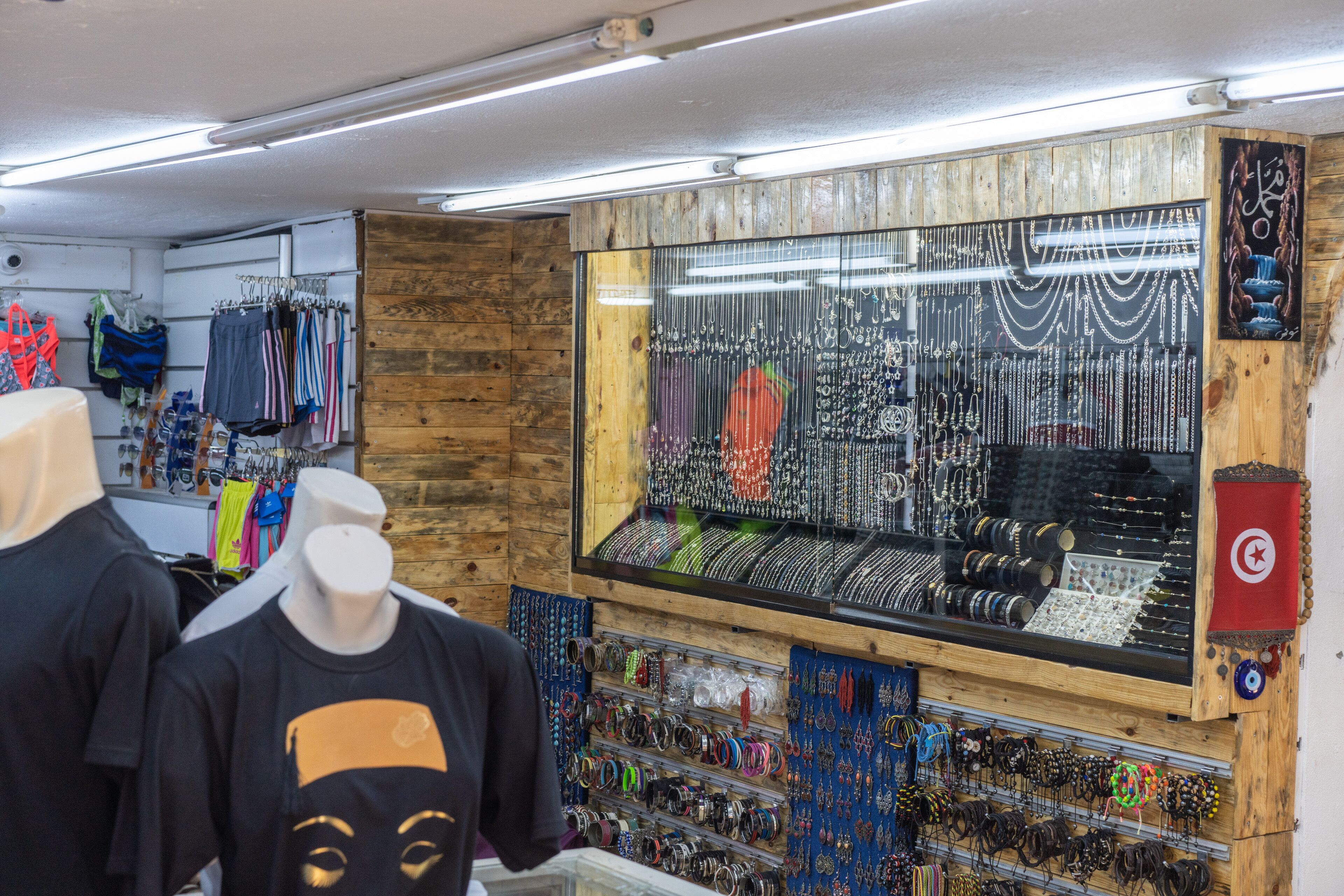 A jewelry store with a display case filled with various necklaces and bracelets.