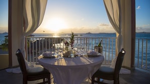 A table set for two with a view of the sea and mountains at sunset. - Simpson Bay Resort, Marina & Spa (Simpson Bay)