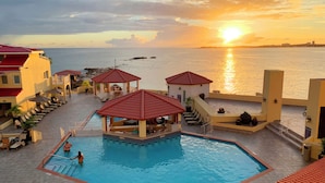 A resort pool area with a view of the sea and sunset. - Simpson Bay Resort, Marina & Spa (Simpson Bay)