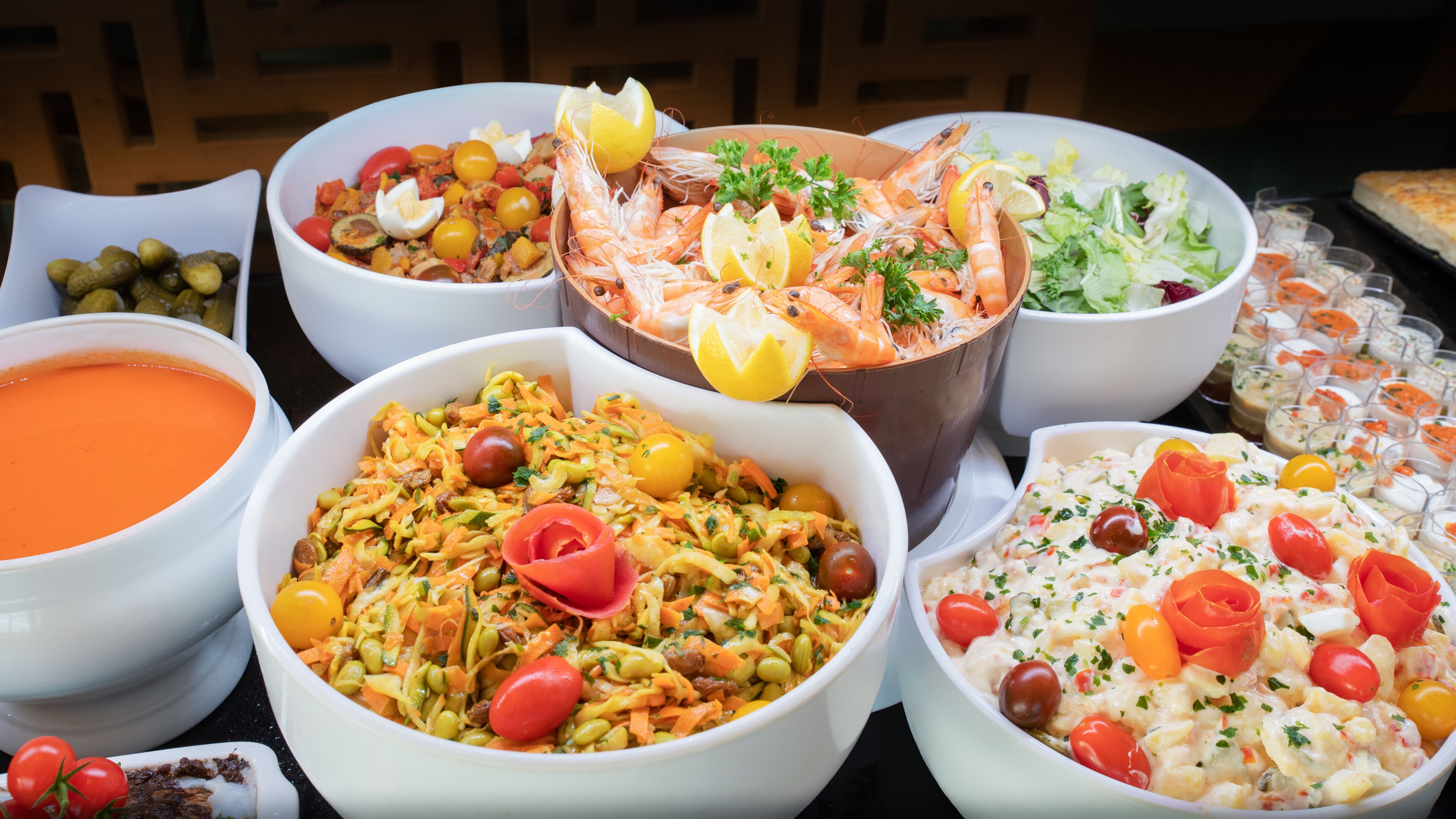 A variety of dishes including seafood, salads, and a bowl of soup.