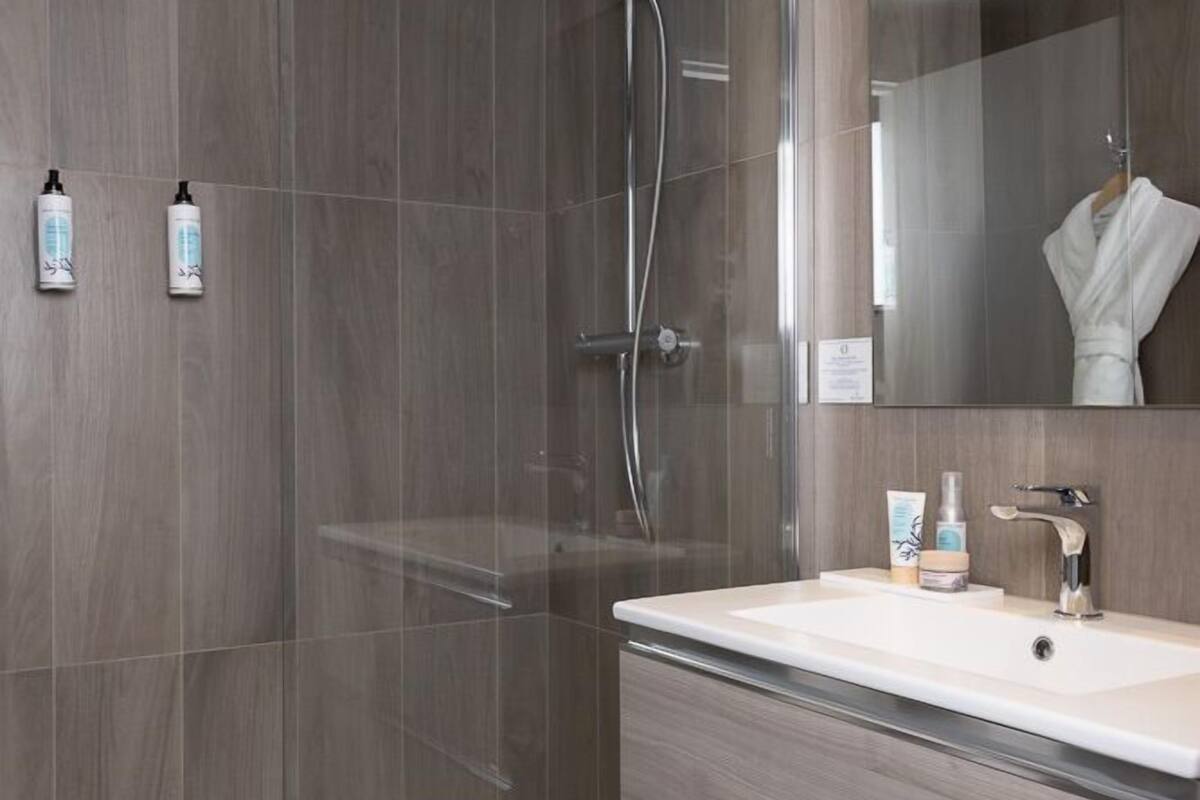 comfort room, ocean view | bathroom | free toiletries, hair dryer, towels