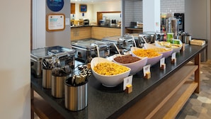 A buffet area with various food options, including cereal and granola, and a coffee station. - Holiday Inn Express Stevenage by IHG (Stevenage)