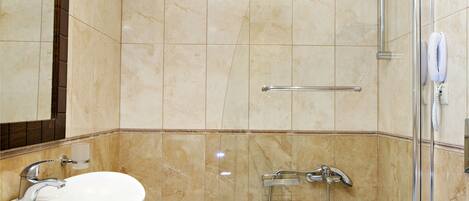 A modern bathroom with a large bathtub, a sink, and a toilet.